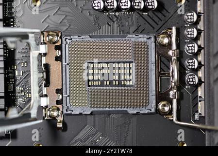 Intel computer CPU socket Alder Lake Socket 1700 with protective cover removed hold down clamp open Stock Photo