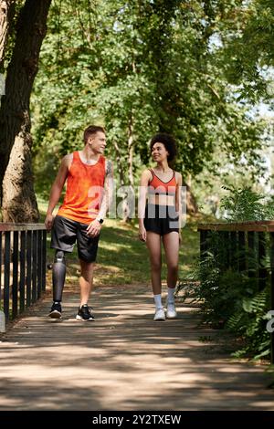 Young friends engage in fitness, walking together on a scenic path surrounded by nature. Stock Photo
