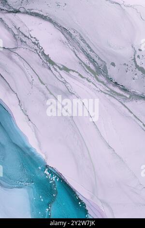 Abstract fluid art showcasing blue and white marbling patterns with hints of metallic gold on a smooth surface Stock Photo