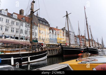 Colorful waterfront buildings and historic sailing boats in Nyhavn, Copenhagen. Iconic Danish harbor, perfect for travel and architecture photography. Stock Photo