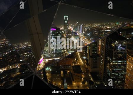 Riyadh, Saudi Arabia – September 11, 2024: Central Riyadh, including the Kingdom Tower, reflected in the globe of Al-Faisaliah Tower Stock Photo