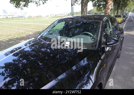 a black car with a parking ticket Stock Photo