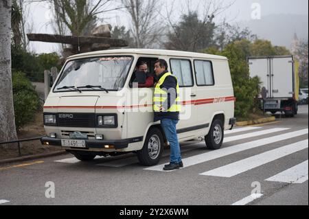 An old van from Spanish manufactures Ebro model F260, off-white with a red line. The driver is talking to a shadow through the window Stock Photo