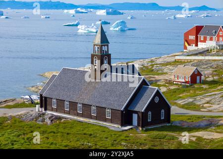 Typical architecture of Greenland Ilulissat with colored houses located near fjords and icebergs. Stock Photo