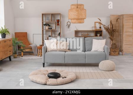 Interior of living room with sofa and glucophone on pouf Stock Photo