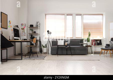 Stylish office with workplace, sofa and photographer gadgets Stock Photo