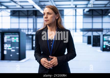 IT expert managing data center with advanced technology, ensuring cybersecurity and efficient network management. Admin in server room maintaining and optimizing data center infrastructure Stock Photo
