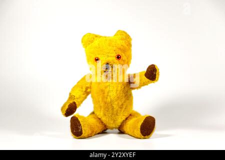 old vintage 1960s teddy bear sitting and waving on white studio background Stock Photo