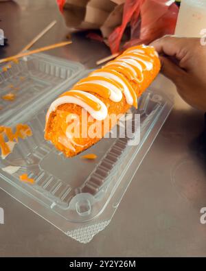 A shot of a corndog with mozzarella cheese inside and drizzled with cheese and mayonnaise on top. Stock Photo
