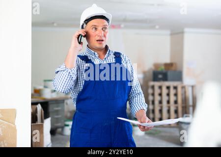 Construction worker having telephone conversation Stock Photo
