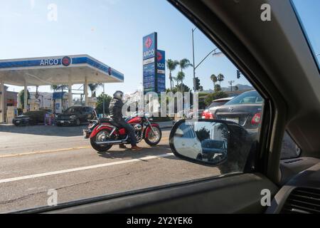 Motorcyclist seen through a car window. Los Angeles, California, United States of America Stock Photo