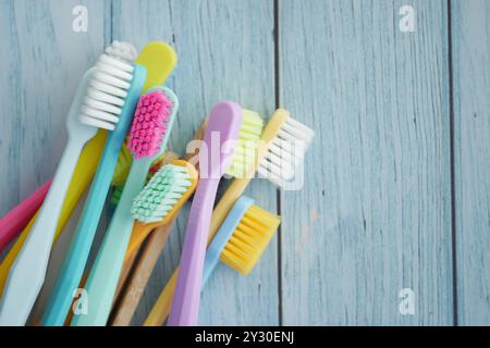 A Vibrant Array of Colorful Toothbrushes Beautifully Arranged on a Wooden Surface Stock Photo