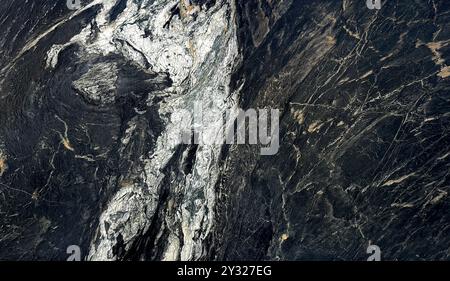 Natural black and white marble slab pattern in rough textured finishes, Fusion Black Panda marble with white veinings, rough stone texture. Seamless Stock Photo