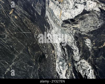 Natural black and white marble slab pattern in rough textured finishes, Fusion Black Panda marble with white veinings, rough stone texture. Seamless Stock Photo