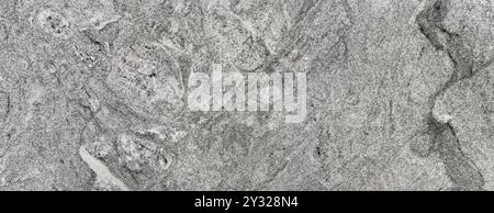 Grey natural granite slab texture. Random ripple pattern, with some dark veinings. Granite is a common natural slab stone used in many countertops Stock Photo