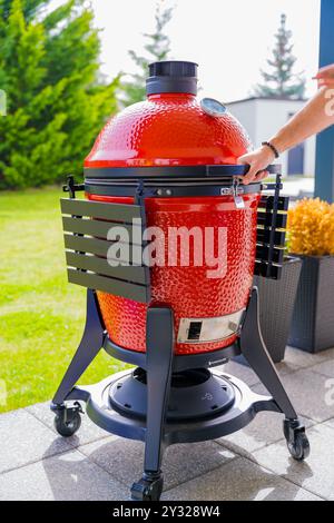 Prague, Czech Republic - March 31, 2024: Modern red ceramic bbq grill tandoor Kamado joe Stock Photo