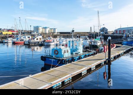 Wick, Scotland, UK - October 23, 2023: Pilot boat and sailing yachts are docked in the harbor on the northeast coast of Scotland in Wick, Caithness, i Stock Photo