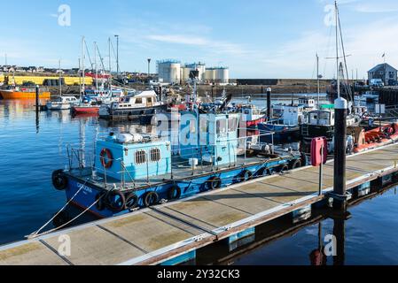 Wick, Scotland, UK - October 23, 2023: Pilot boat and sailing yachts are docked in the harbor on the northeast coast of Scotland in Wick, Caithness, i Stock Photo