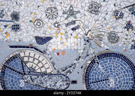 Mosaic artwork in Delft Blue with colorful ceramic tiles, shards and pieces of mirror glass in 'De Bonte Ossteeg' alley in Delft Stock Photo