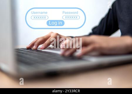 A close-up image of a person using a laptop with a login screen displayed. Privacy and security concept. Stock Photo