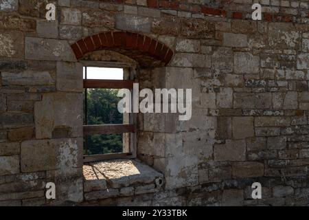 Arched weathered window in the ruin of the medieval Neuenburg castle surrounded by a shell limestone wall, Freyburg, Saxony-Anhalt, Germany Stock Photo