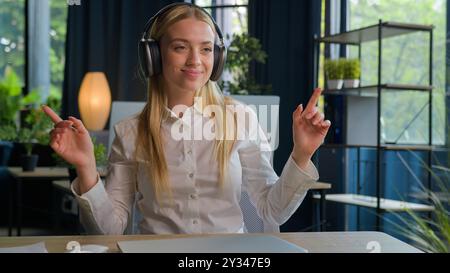 Caucasian businesswoman finish computer work stretching at office desk happy relaxed business woman female worker stress relief after job well done Stock Photo