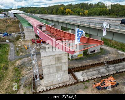 12 September 2024, Saxony, Grimma: The new Mulde bridge on the A14 near Grimma is being pushed over the Mulde valley using the incremental launching method in the third of seven planned shifts. This means that the bridge will grow by 40 meters in length within two days. The structure is to replace the old highway bridge from the 1970s, according to the highway construction company Deges. The new bridge will be 361 meters long and will cross the Mulde River at a height of around 21 meters. The project costs of 81 million euros will be borne by the federal government. Completion is planned for 2 Stock Photo