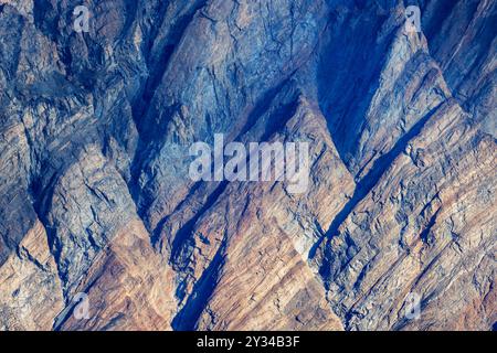 Colorful rock formation detail in Northeast Greenland National park. Mountainside geological formation forming an abstract triangle pattern with layer Stock Photo