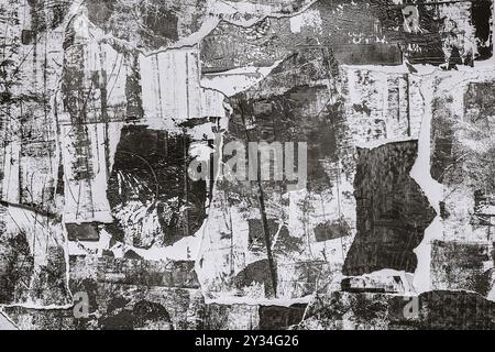 Abstract grunge black and white backdrop with scraps of paper and black paint spots. Torn paper texture and painting stains background. Stock Photo