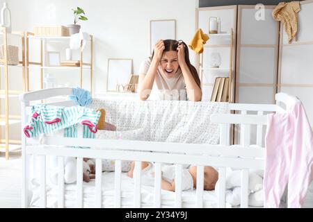 Young mother suffering from postnatal depression at home Stock Photo