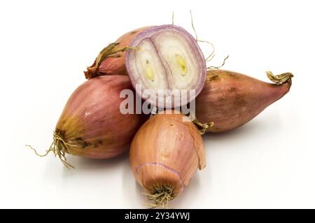 Vegetables: several isolated shallots, one cut in half on a white background Stock Photo