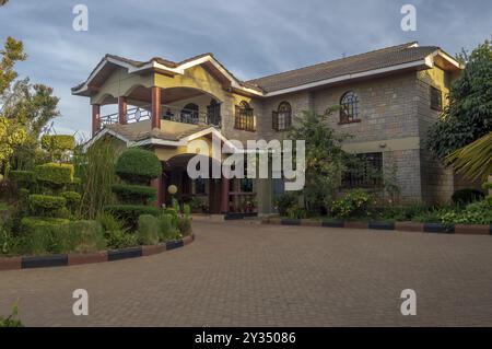 Apartment house with a beautiful entrance porch and a flower bed in the city of Nairobi in Kenya Stock Photo