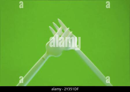Fork white with plastic snack bar on green bottom Stock Photo