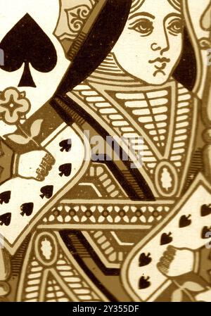 Close up of a vintage queen of spades playing card in sepia on a pale cream background. Stock Photo