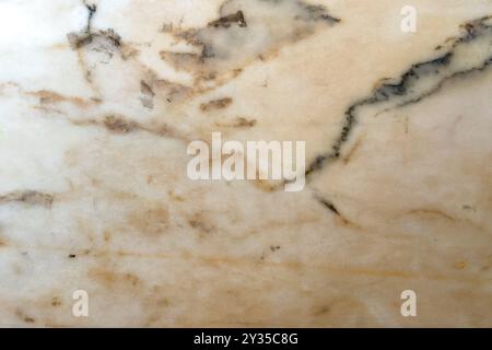 A stunning marble surface highlights beautiful natural patterns of beige and gray hues, ideal for creative interior design projects and elegant spaces Stock Photo