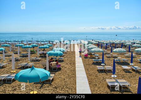 Spiaggia Lignano, Italy - September 7, 2024: Lignano beach, Italy, with parasols and sun loungers in summer *** Strand von Lignano, Italien, im Sommer mit Sonnenschirmen und Liegestühlen Stock Photo