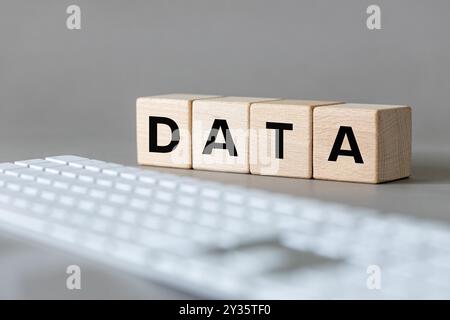 Data concept. The word DATA written on wooden cubes on a computer keyboard background. Data storage concept Stock Photo
