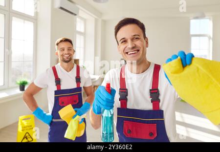 Male cleaners, male professional cleaning service team working together  Stock Photo