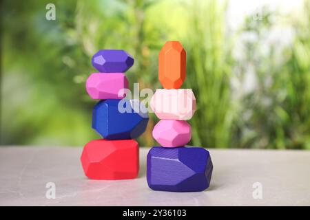 Many colorful balancing stones on light grey outdoors Stock Photo