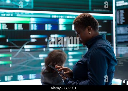 Governmental hackers execute cyber attacks by breaking passwords, compromising online security. Specialists infiltrate digital networks, breaching security protocols. Cyber surveillance. Stock Photo