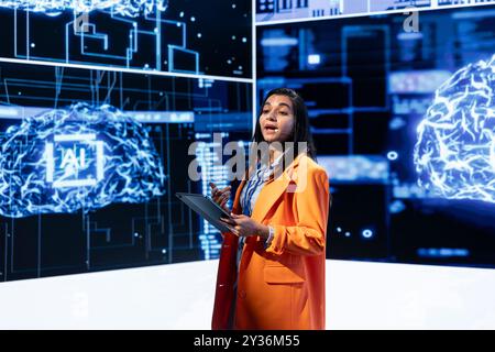 Speaker does presentation during tech corporate event, exploring successful implementation of AI in driving forward startup businesses, sharing latest machine learning discoveries Stock Photo