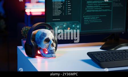 Desk with decorations in empty criminals den and hacking software interface on PC screens. Equipment in apartment used for deploying malware programming script on displays in underground base Stock Photo