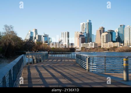 Austin, Texas - February 22, 2024: City of Austin Texas with people on outdoor path along the river with skyline buildings in the background. Stock Photo