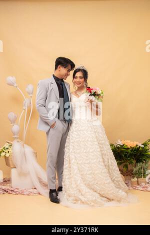 expressions of male and female couples standing relaxed laughing looking at the front of the woman intimately indoor photo shot. couple wedding nation Stock Photo
