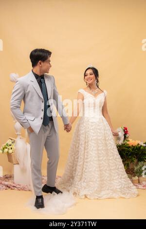 male and female couple walking poses looking at each other intimately indoor photo shot. couple wedding national bride studio Stock Photo