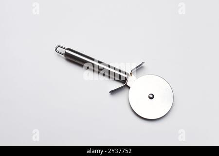 Stainless steel pizza cutter on a white background Stock Photo