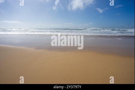 Looking out to sea, ocean straight on, waves crashing, surf breaking, seawater washing onto a sandy sub tropical beach in Queensland Stock Photo