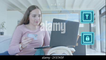 Image of padlock and key icons and data over caucasian woman paying online with card Stock Photo