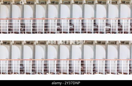 Exterior view of cabins of a modern cruise ship. Cruise liner balconies, ready for passengers to enjoy a scenic ride Stock Photo