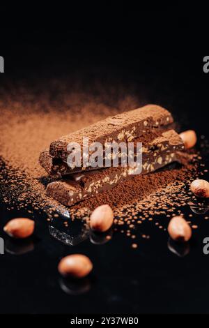 Chocolate bars with nuts and cocoa powder falling, captured in a ...
